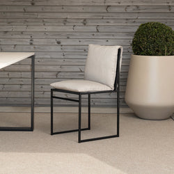 Isa outdoor chair in black frame with fossil acrylic, featuring minimalist Scandinavian design for timeless elegance.