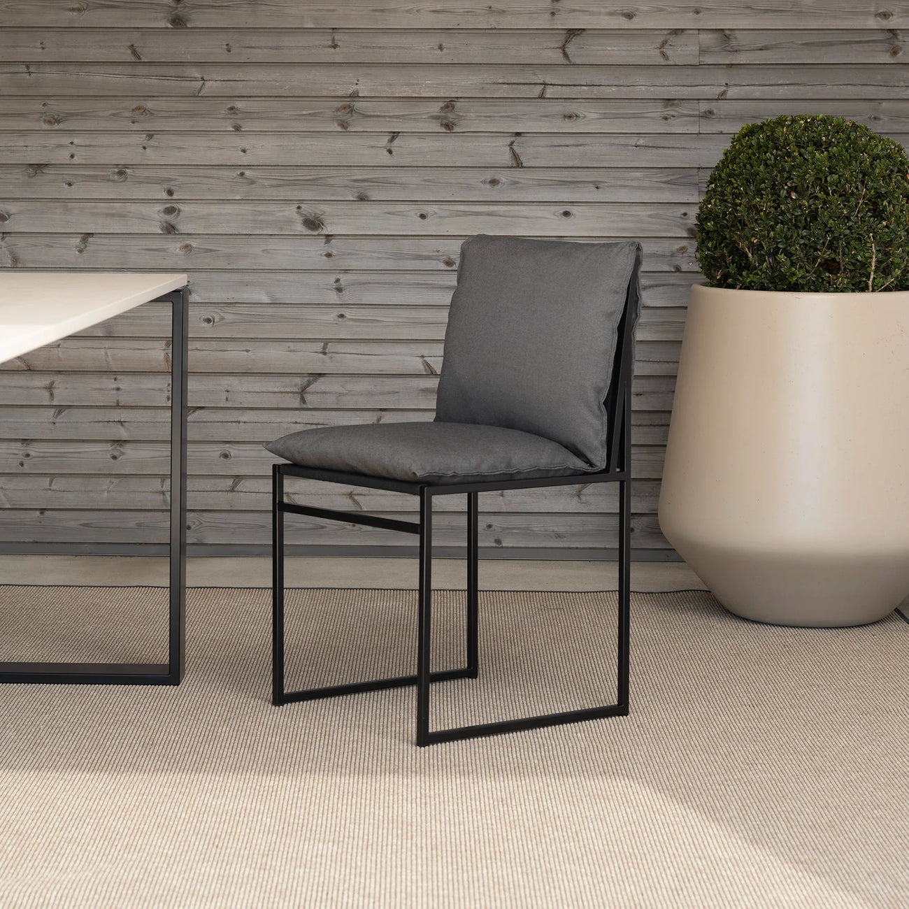 Isa Outdoor chair in black with onyx acrylic cushion, enhancing modern outdoor aesthetics.