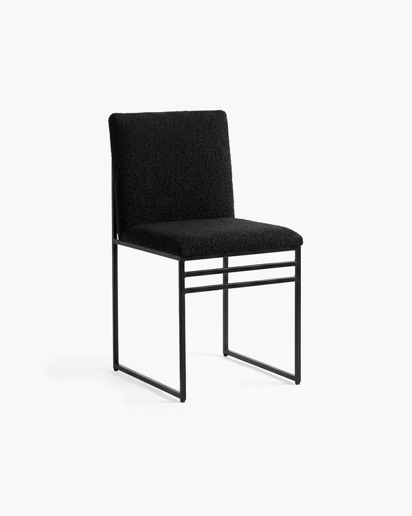 Dining Chair Isabell by Crea in black bouclé on a black powder-coated steel frame, three-quarter view