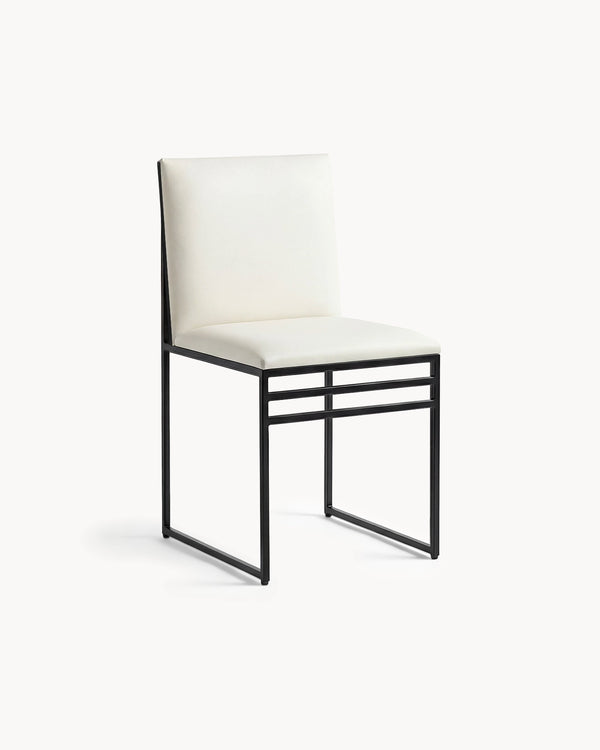 Dining Chair Isabell by Crea in ivory vegan leather on a black powder-coated steel frame, three-quarter view
