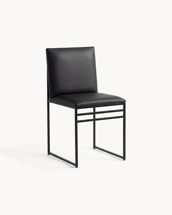 Dining Chair Isabell by Crea in jade black vegan leather on a black powder-coated steel frame, three-quarter view