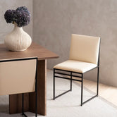 Dining chair Isabell with sand leather cushion and black frame, elegant design for modern dining spaces.