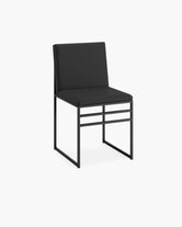 Isabell dining chair with minimalistic silhouette, curved back, ideal for Scandinavian interiors, featuring a black finish.