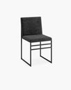 Elegant Isabell dining chair in black velvet with a sleek matching frame, perfect for modern dining spaces.