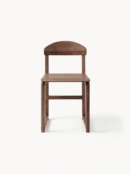 Karin wooden stool in solid dark-stained oak with minimalist Scandinavian design and handcrafted details against a soft neutral background.