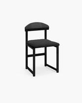 Dining chair Karin with black oak wood frame and black bouclé cushion, stylish and timeless design.
