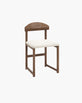 Karin dining chair with dark oak frame and ivory bouclé seat, showcasing modern design with rich wood and soft texture.