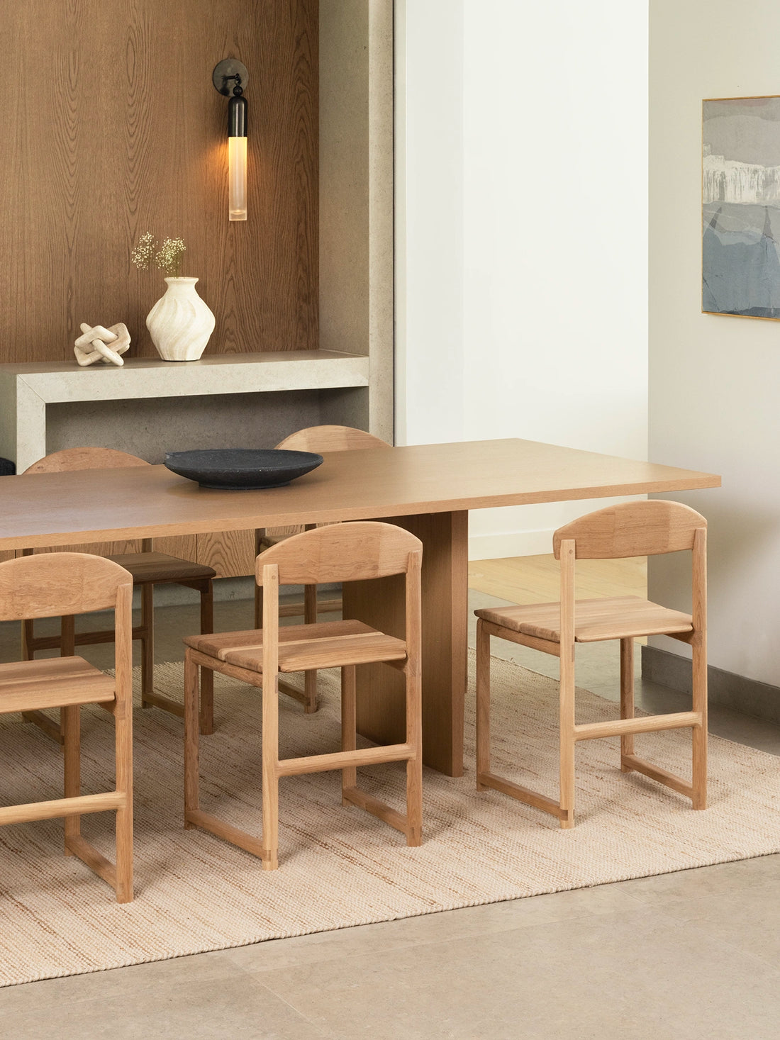 Scandinavian dining setting featuring Karin dining chair in oak wood frame and a modern dining table.