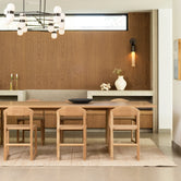 Karin dining chairs in oak arranged around a stylish dining table in a modern Scandinavian-inspired setting.