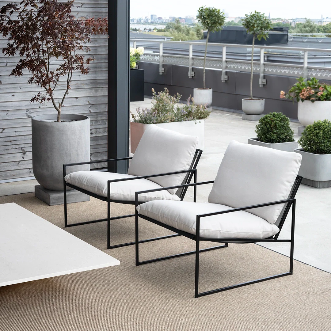 Kenny lounge chair in black with marble acrylic, offering modern style and comfort for outdoor relaxation.