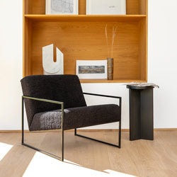 Kent Armchair in black bouclé, showcasing minimalist Scandinavian design in a contemporary living space.