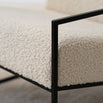 Close-up of ivory bouclé texture on Kent armchair with black frame, showcasing Nordic minimalism and comfort.
