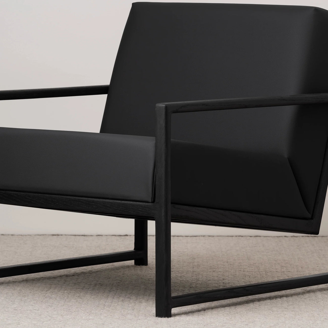 Kent Wood armchair in black oak with jade black leather seat, featuring stylish Scandinavian design and modern comfort.