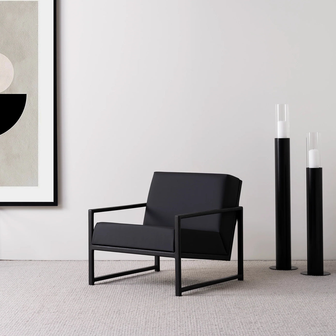 Black oak armchair with jade black leather seat, showcasing sleek Scandinavian design in a modern interior.