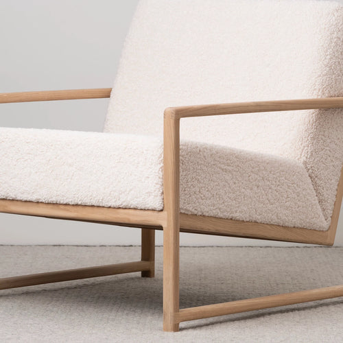 Kent oak armchair with ivory bouclé upholstery, perfect for modern Scandinavian interiors and relaxed living spaces.