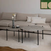 Leo Coffee Table 2-set by by Crea with Grigio Dekton tops and black steel frames, styled in a Scandinavian living room with ceramic vase, patterned bowl, and cream corner sofa. Handmade designer coffee tables for modern interiors.