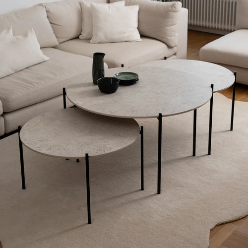 Leo Coffee Table 3-set by by Crea with Sabbia Dekton tops and black steel frames, styled in a Scandinavian living room with a cream sectional sofa and wool rug. Handmade modern coffee tables for designer interiors.