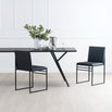 Melker Dining table in black oak with sleek black chairs and floral centerpiece, ideal for modern dining spaces.