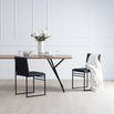 Melker dining table in black with oak top, surrounded by modern chairs and decorative vase, showcasing stylish dining setup.