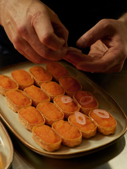 Close-up of Kalix löjrom canapés being finished by hand during the Norrbottens Destilleri grand opening.