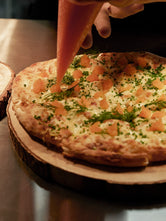 Close-up of a flatbread topped with löjrom, dill and chives during the Norrbottens Destilleri grand opening.