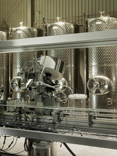 Stainless steel production tanks and bottling machinery inside Norrbottens Destilleri during the grand opening.