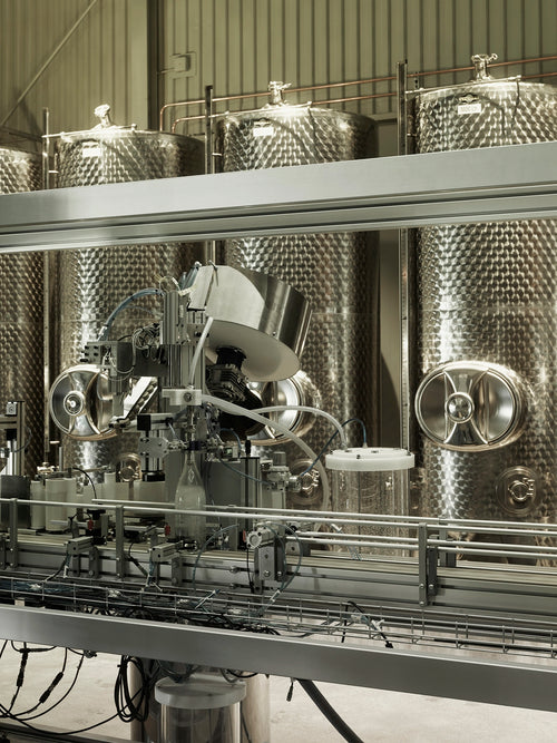 Stainless steel production tanks and bottling machinery inside Norrbottens Destilleri during the grand opening.