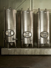 Three stainless steel distillery production tanks inside Norrbottens Destilleri.