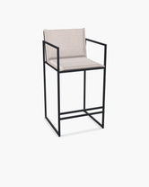 Outdoor Bar Stool Folke with black powder-coated stainless steel frame and Oat olefin cushion.
