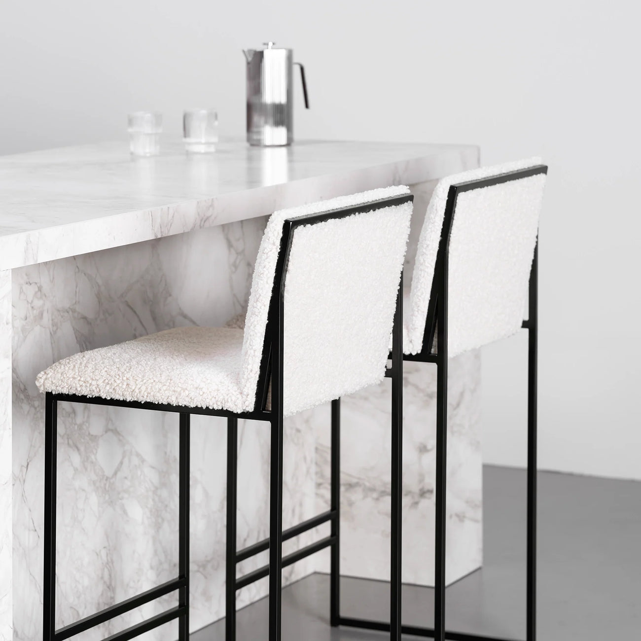 Philip bar stool in black with ivory bouclé seat, modern design with high backrest, ideal for contemporary kitchens.