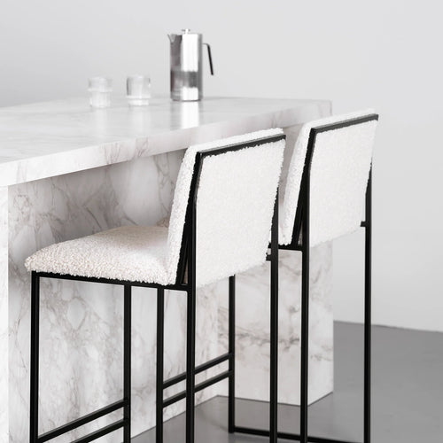 Philip bar stool in black with ivory bouclé seat, modern design with high backrest, ideal for contemporary kitchens.