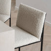 Philip bar stool with an ivory bouclé seat and black metal frame, showcasing modern design and high backrest for comfort.