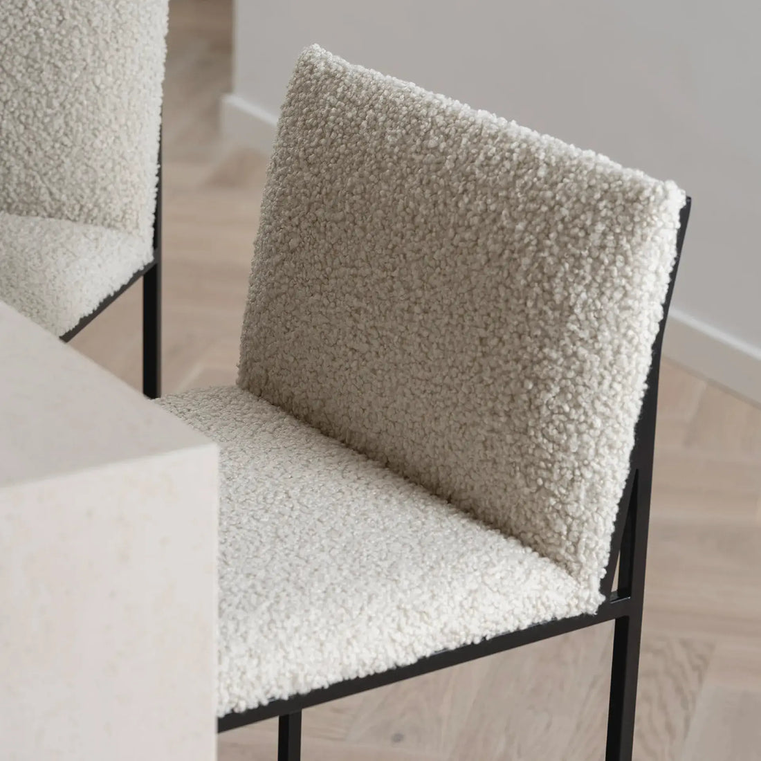 Bar Stool with black frame and ivory bouclé cushion, designed for modern kitchens and bars.