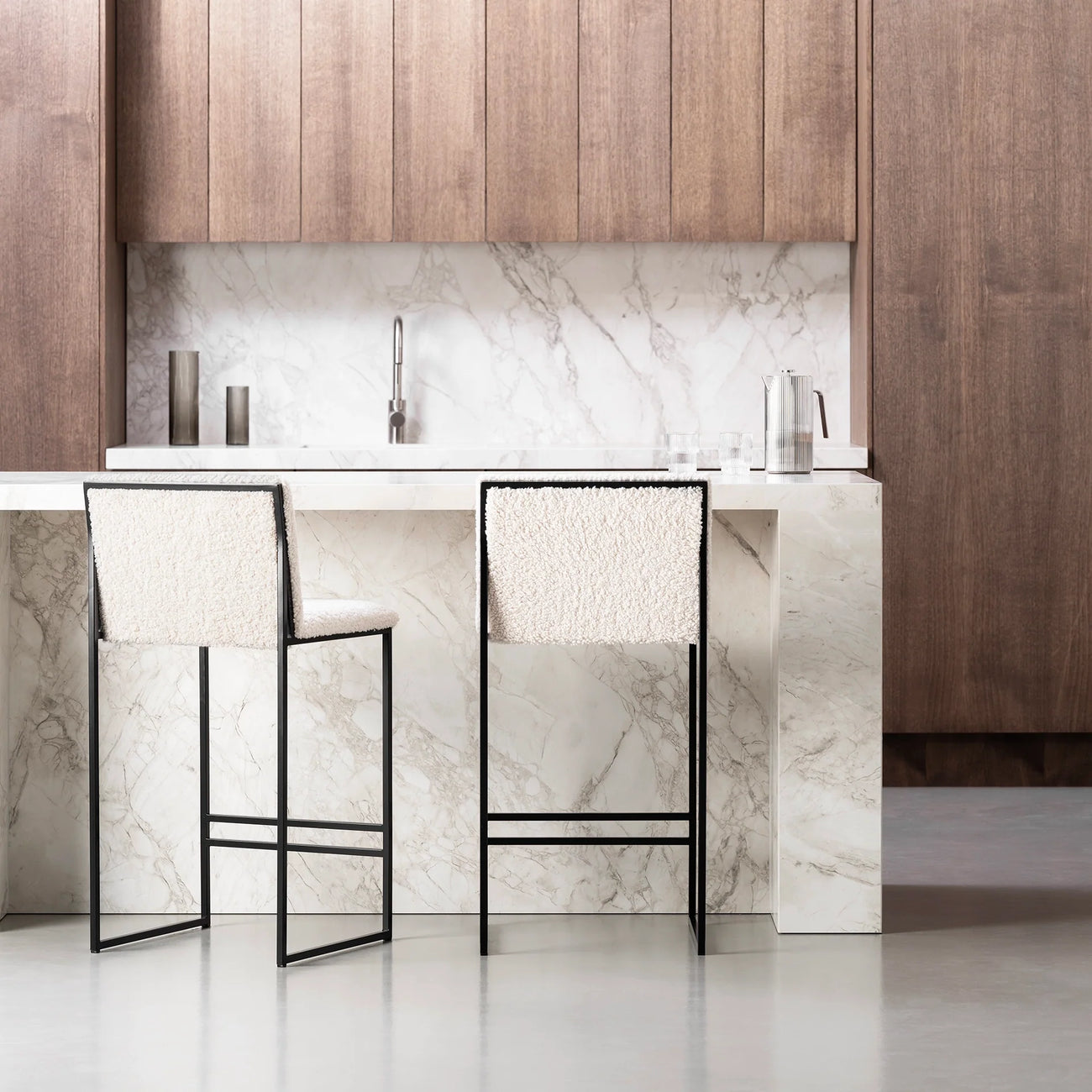 Philip Bar stool in black with ivory bouclé seat, showcasing modern design and high backrest, in a stylish kitchen setting.