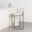 Philip bar stool with black frame and ivory leather seat, perfect for modern interiors, featuring a sleek silhouette.