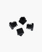 Set of four stylish black plastic feet for furniture protection and floor safety.