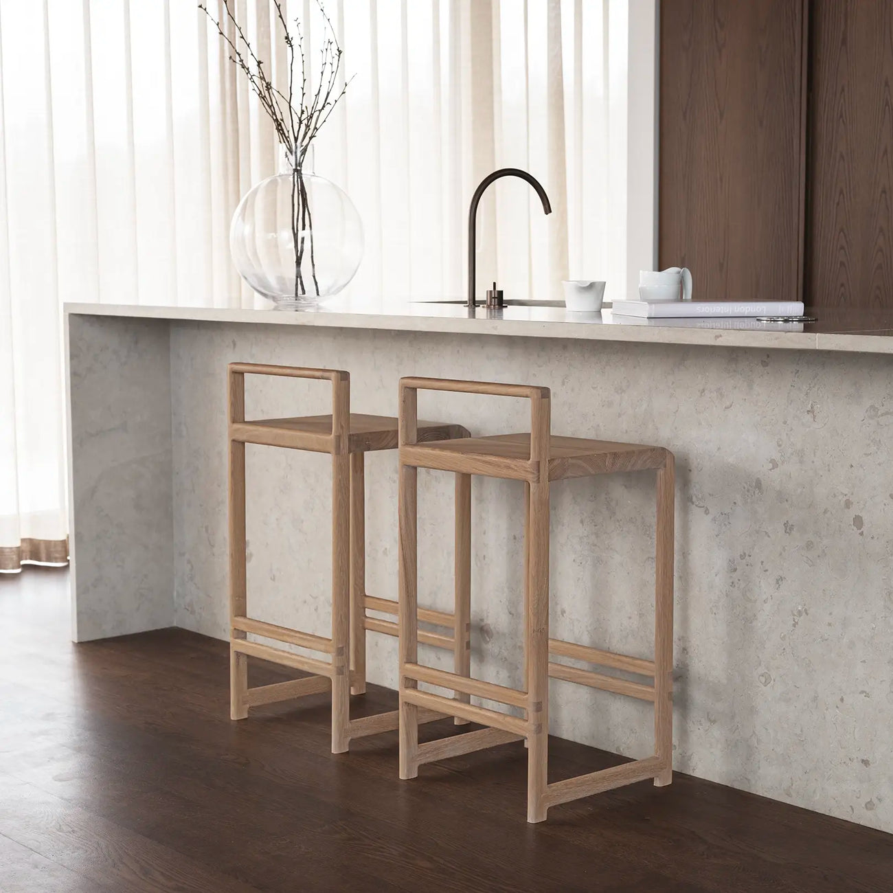 Ebba bar stools in oak at a modern kitchen counter with minimalist design and natural wood finish.