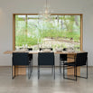 Modern dining space featuring Sella dining chairs in black leather around a stylish wooden table.