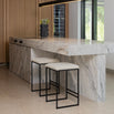 Svea bar stools with ivory bouclé seats and black frames by a modern marble kitchen island.