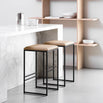 Svea bar stools with black frame and latte leather seat, minimalistic design for modern kitchen or dining area.