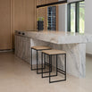 Svea bar stools with black frame and latte leather seats at a marble kitchen island.