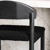 Ted bar stool in black oak with black bouclé seat, showcasing sleek design and tone-on-tone texture.