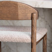 Dark oak Ted bar stool with greige bouclé seat, perfect for stylish elevated dining spaces.