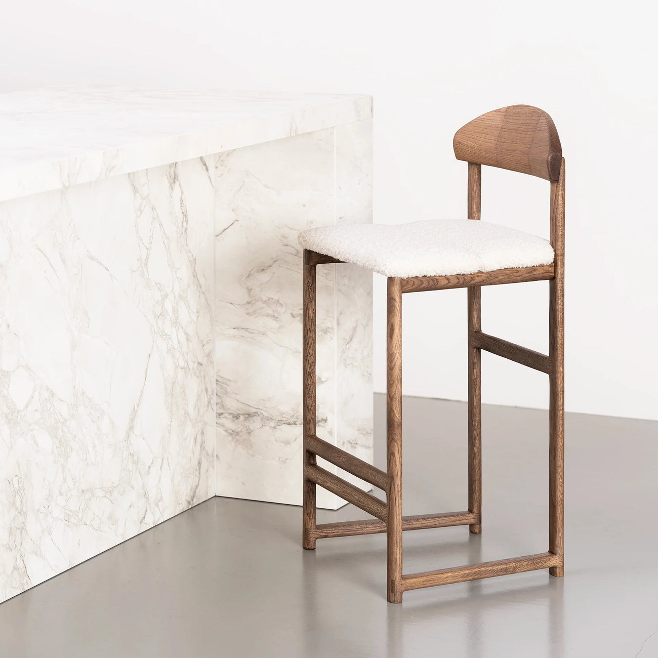 Ted bar stool in dark oak with ivory bouclé seat, perfect for kitchens and bar areas.