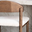 Dark oak bar stool with ivory bouclé seat, ideal for kitchens and bar areas, showcasing elegance and comfort.