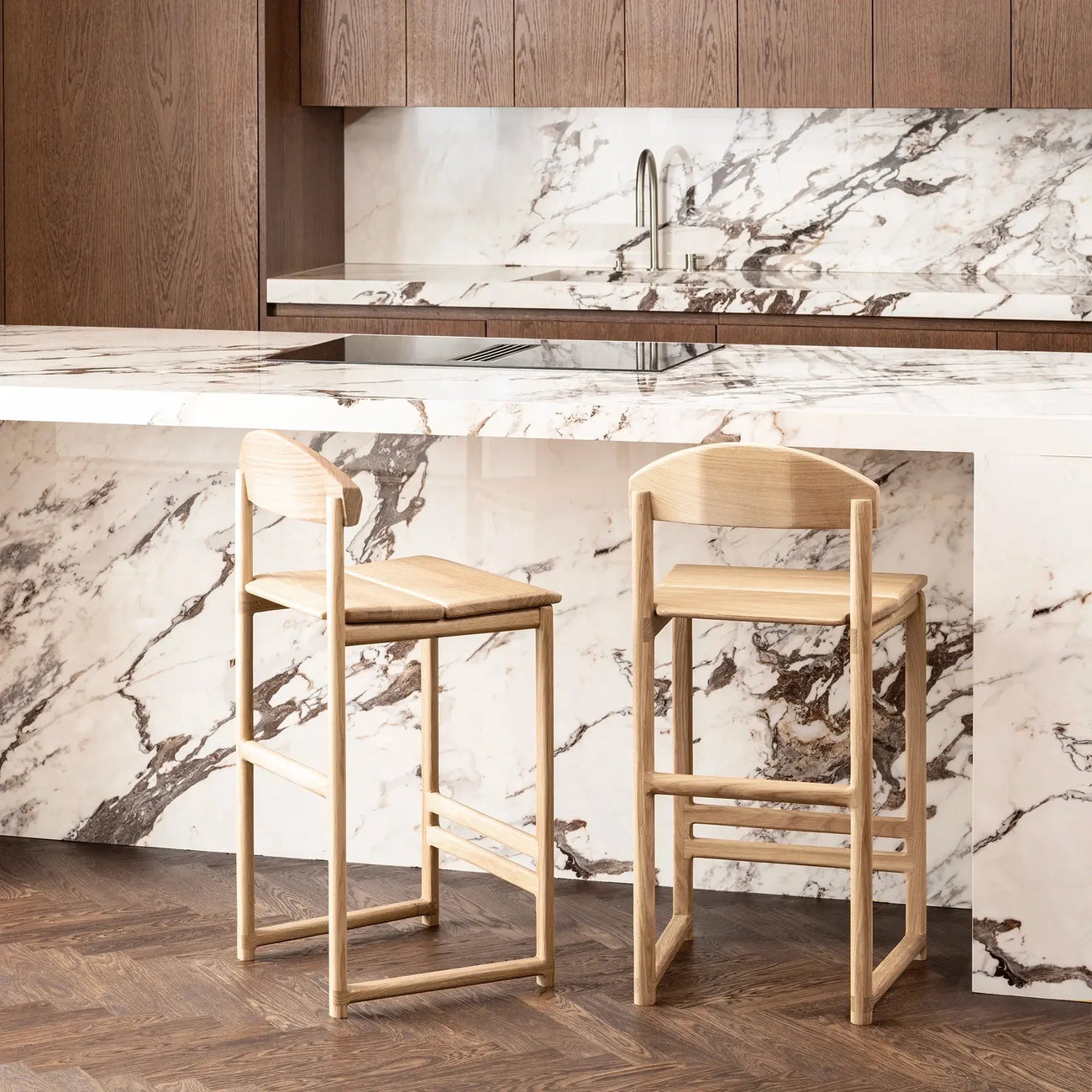 Ted bar stool in solid oak, minimalistic design, stylishly placed at a modern kitchen island with marble countertop.