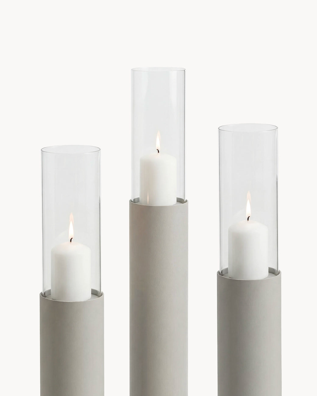 Candleholder Thomas set of 3 in beige frame with clear glass cylinders and white candles.