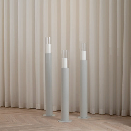 Beige floor candleholder set featuring three sculptural designs, perfect for modern Nordic interiors.