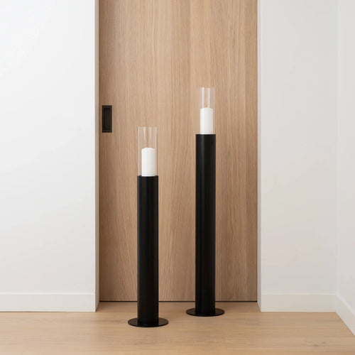 Thomas Floor candleholder set in black with light glass cylinders, perfect for adding elegance to any room.