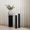 Scandinavian black floor candleholders with clear glass cylinders, perfect for home decor.